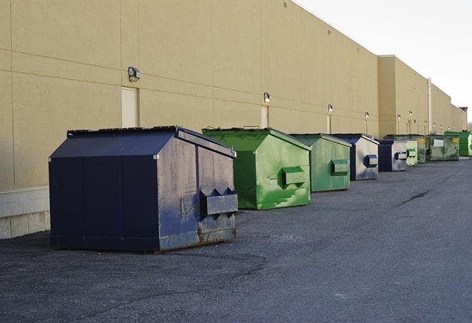 a stack of yellow construction dumpsters on a job site in Ames IA